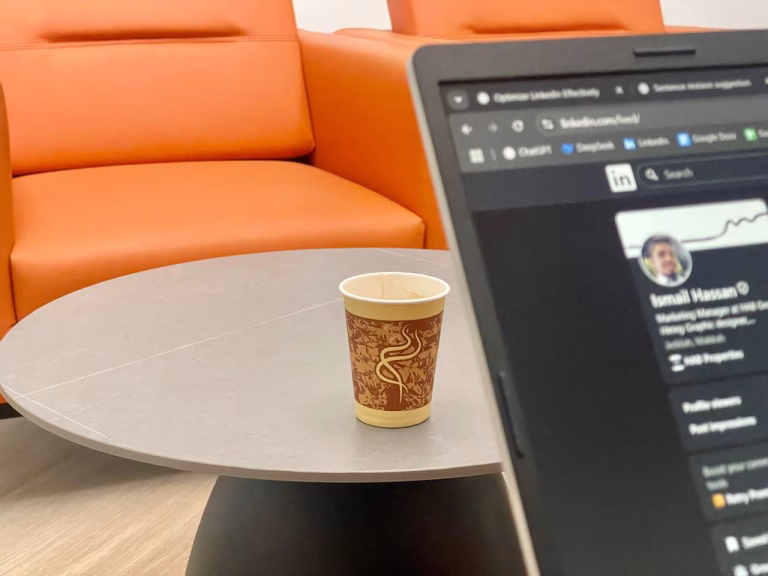 I took this photo while sitting on the office sofa — the coffee cup in focus, with my laptop intentionally blurred in the foreground. I captured this moment while working on this very article.